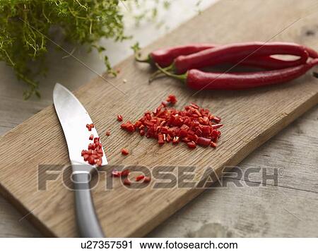 Stock Image - Knife with chopped chili pepper. Fotosearch