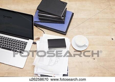 Laptop with books and coffee cup View Large Photo Image Stock Image - Laptop with books and coffee cup. Fotosearch