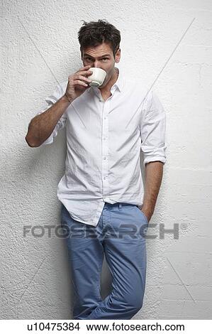 Man drinking cup of coffee View Large Photo Image Picture - Man drinking cup of coffee. Fotosearch
