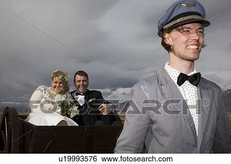 Man driving newlyweds in wooden cart View Large Photo Image Stock Photograph - Man driving newlyweds in wooden cart. Fotosearch