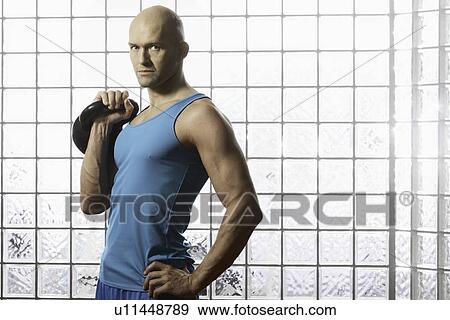 Man lifting weights in gym View Large Photo Image Stock Photo - Man lifting weights in gym. Fotosearch