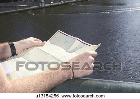 Man reading city map on bridge View Large Photo Image Stock Photograph - Man reading city map on bridge. Fotosearch
