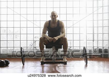 Man sitting with weights in gym View Large Photo Image Stock Photo - Man sitting with weights in gym. Fotosearch