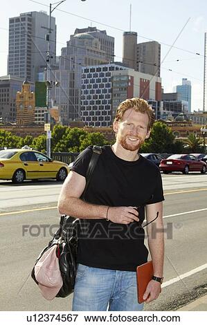 Stock Photo - Man standing on city street. Fotosearch