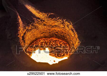 Stock Image - Molten metal in flask in foundry. Fotosearch