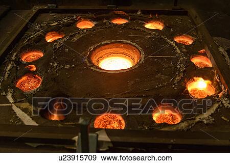 Stock Photo - Molten metal in moulds in foundry. Fotosearch