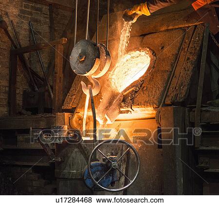Stock Photo - Molten metal pouring in foundry. Fotosearch