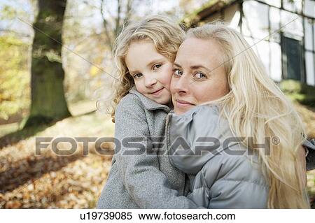 Mother and daughter hugging outdoors View Large Photo Image Stock Photography - Mother and daughter hugging outdoors. Fotosearch