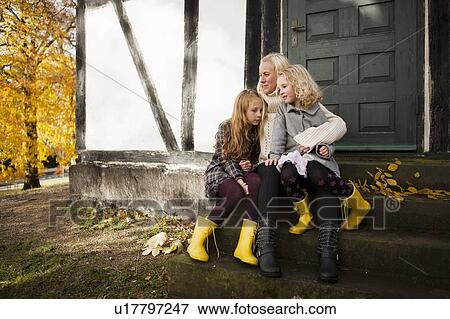 Mother and daughters sitting outdoors View Large Photo Image Stock Photo - Mother and daughters sitting outdoors. Fotosearch
