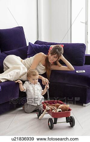Mother and son relaxing in living room View Large Photo Image Stock Photo - Mother and son relaxing in living room. Fotosearch