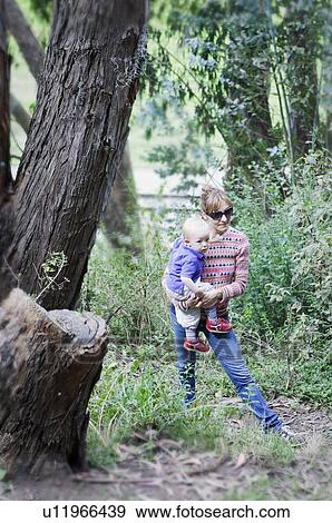 Mother and son walking in forest View Large Photo Image Stock Photo - Mother and son walking in forest. Fotosearch