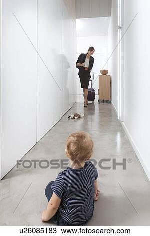 Stock Image - Mother returning from business trip. Fotosearch