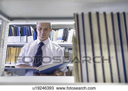 Stock Image - Nautical student reading in library. Fotosearch