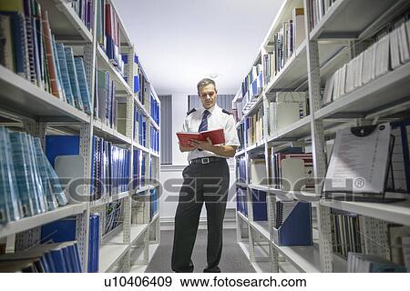 Stock Photo - Nautical student reading in library. Fotosearch