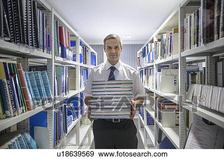Stock Photo - Nautical student with books in library. Fotosearch