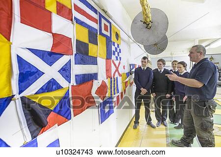 Stock Image - Nautical students learning signal flags. Fotosearch