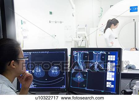 Nurse examining x-rays in hospital View Large Photo Image Stock Photo - Nurse examining x-rays in hospital. Fotosearch