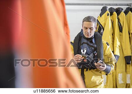 Stock Photograph - Oil worker holding mouthpiece. Fotosearch