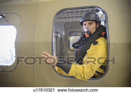 Stock Image - Oil worker in simulated helicopter. Fotosearch