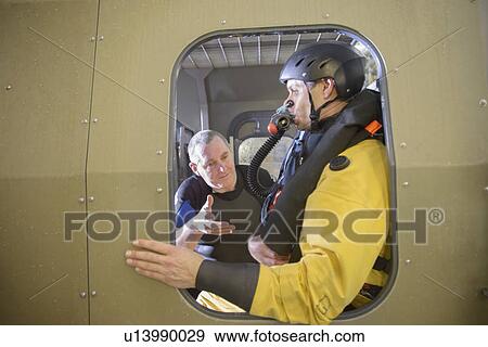 Oil workers in simulated helicopter View Large Photo Image Stock Photo - Oil workers in simulated helicopter. Fotosearch