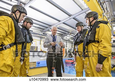 Stock Image - Oil workers learning survival strategies. Fotosearch
