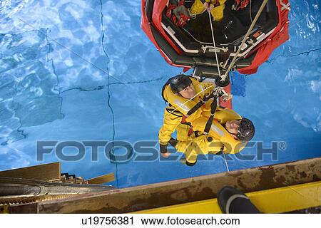Stock Image - Oil workers learning survival strategies. Fotosearch