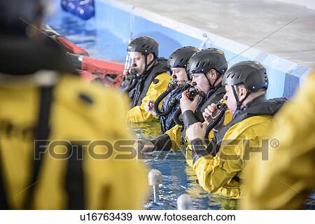 Stock Photo - Oil workers learning survival strategies. Fotosearch