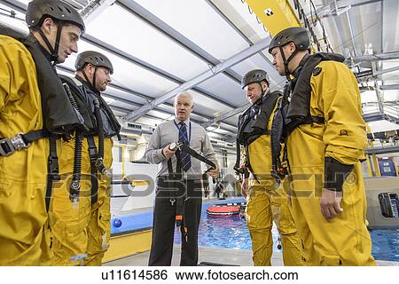 Stock Photograph - Oil workers learning survival strategies. Fotosearch