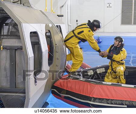 Stock Photography - Oil workers learning survival techniques. Fotosearch