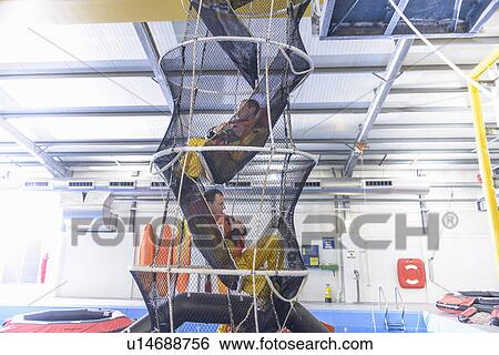 Stock Photograph - Oil workers training in escape net. Fotosearch