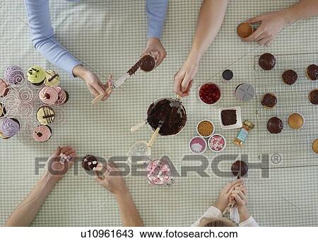 Overhead view of people decorating cakes View Large Photo Image Stock Image - Overhead view of people decorating cakes. Fotosearch