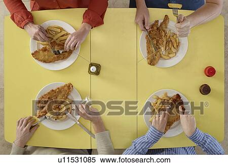 Overhead view of people eating together View Large Photo Image Stock Photography - Overhead view of people eating together. Fotosearch