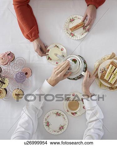 Overhead view of people having tea View Large Photo Image Picture - Overhead view of people having tea. Fotosearch