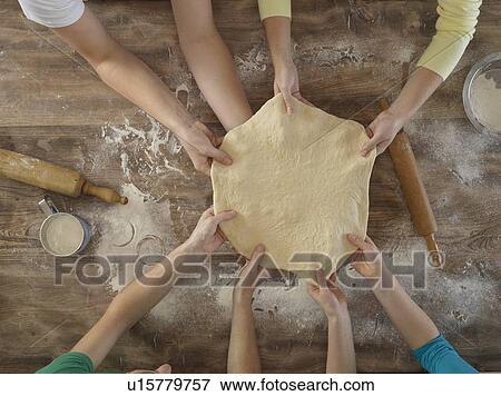 Stock Photo - Overhead view of people making bread. Fotosearch