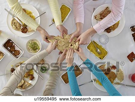 Overhead view of people sharing at table View Large Photo Image Stock Photography - Overhead view of people sharing at table. Fotosearch