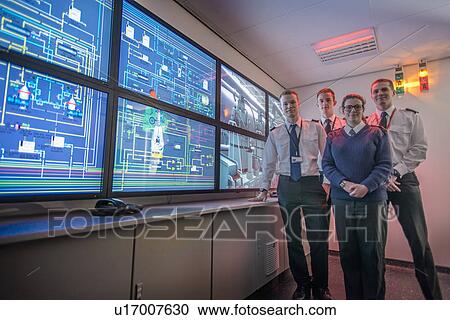 Personnel standing in ships engine room View Large Photo Image Stock Image - Personnel standing in ships engine room. Fotosearch