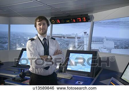 Stock Photograph - Personnel standing on ships bridge. Fotosearch