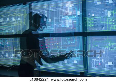 Picture - Personnel working in ships engine room. Fotosearch