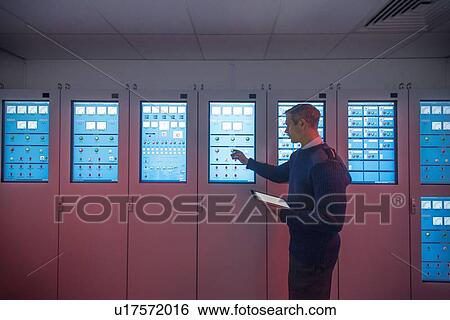 Personnel working in ships engine room View Large Photo Image Stock Photograph - Personnel working in ships engine room. Fotosearch