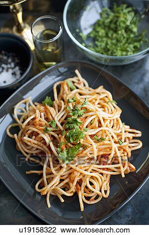 Stock Image - Plate of pasta with herbs. Fotosearch