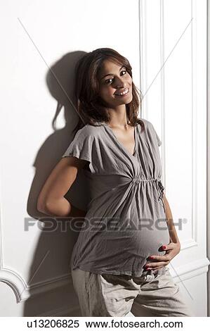 Pregnant woman holding her belly View Large Photo Image Stock Photography - Pregnant woman holding her belly. Fotosearch