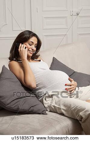 Pregnant woman talking on cell phone View Large Photo Image Stock Image - Pregnant woman talking on cell phone. Fotosearch