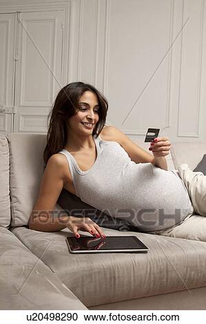 Pregnant woman using tablet computer View Large Photo Image Stock Image - Pregnant woman using tablet computer. Fotosearch
