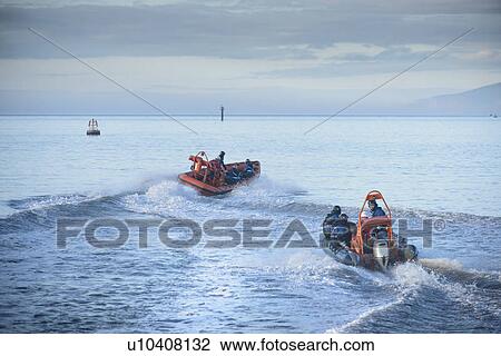 Stock Image - Rescue boat training in open water. Fotosearch