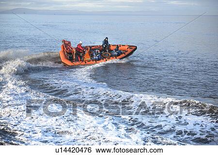 Stock Photograph - Rescue boat training in open water. Fotosearch