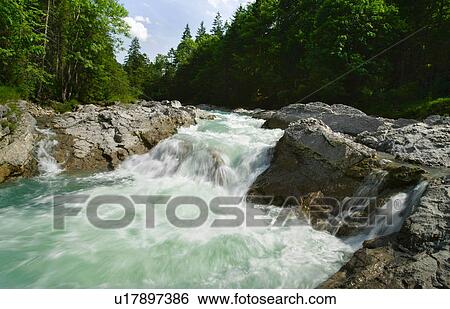 Stock Photograph - Rocky river in rural landscape. Fotosearch