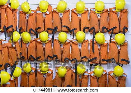 Safety vests and hard hats on wall View Large Photo Image Stock Image - Safety vests and hard hats on wall. Fotosearch