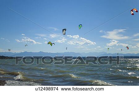 Sails of kitesurfers over choppy waves View Large Photo Image Picture - Sails of kitesurfers over choppy waves. Fotosearch
