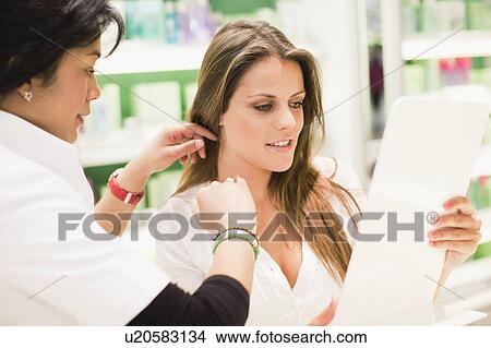Picture - Sales clerk helping customer in store. Fotosearch