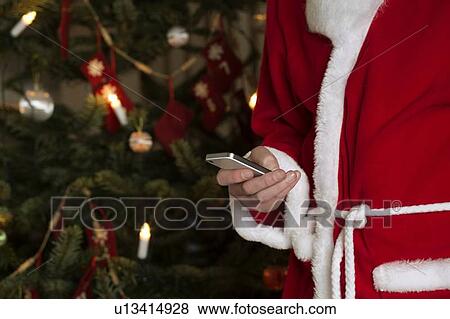 Santa Claus using cell phone View Large Photo Image Stock Photo - Santa Claus using cell phone. Fotosearch